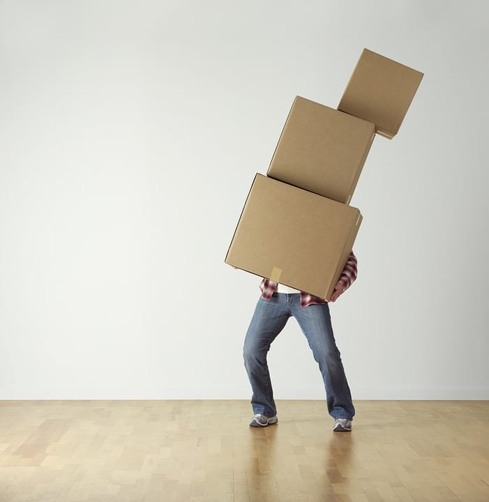 Packaging materials - 10 things to remember when moving home - person carrying boxes