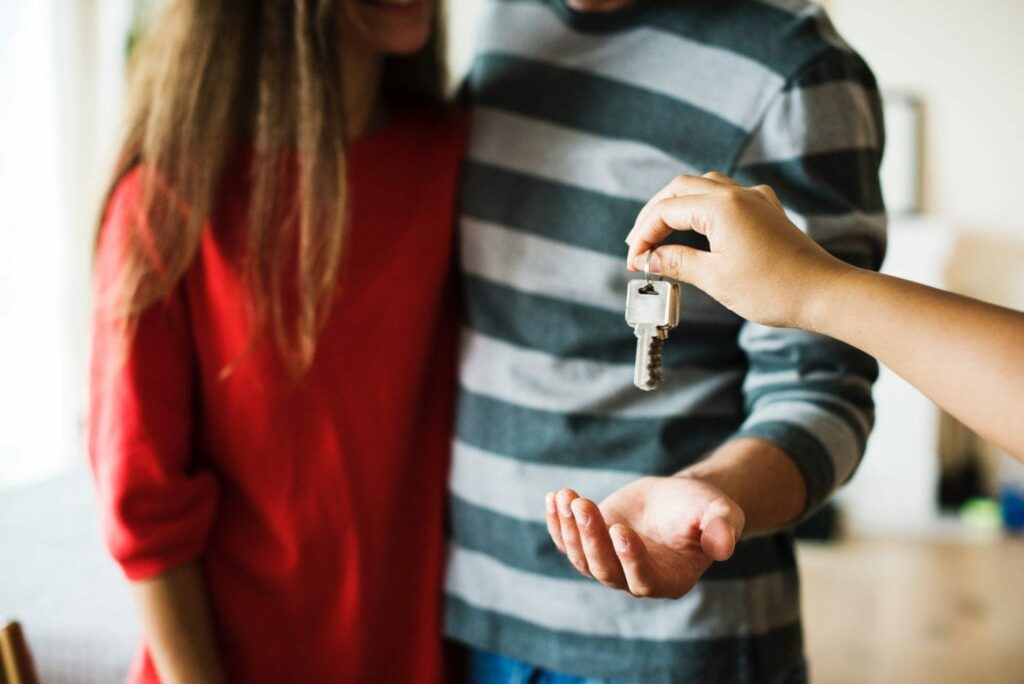Collect all keys - 10 things to remember when moving home - person handing keys over