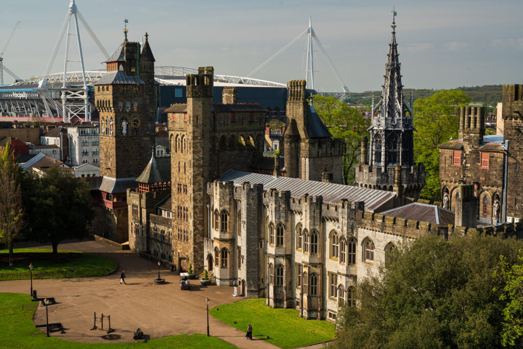 Exterior shot of Cardiff Castle, with the Principality Stadium featuring in the background.