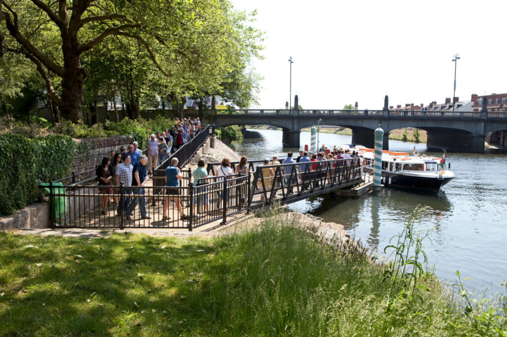 Large crowd of people queueing for a boat trip in Bute park - Cardiff boat tours are ranked as top things to do in Cardiff 2023.