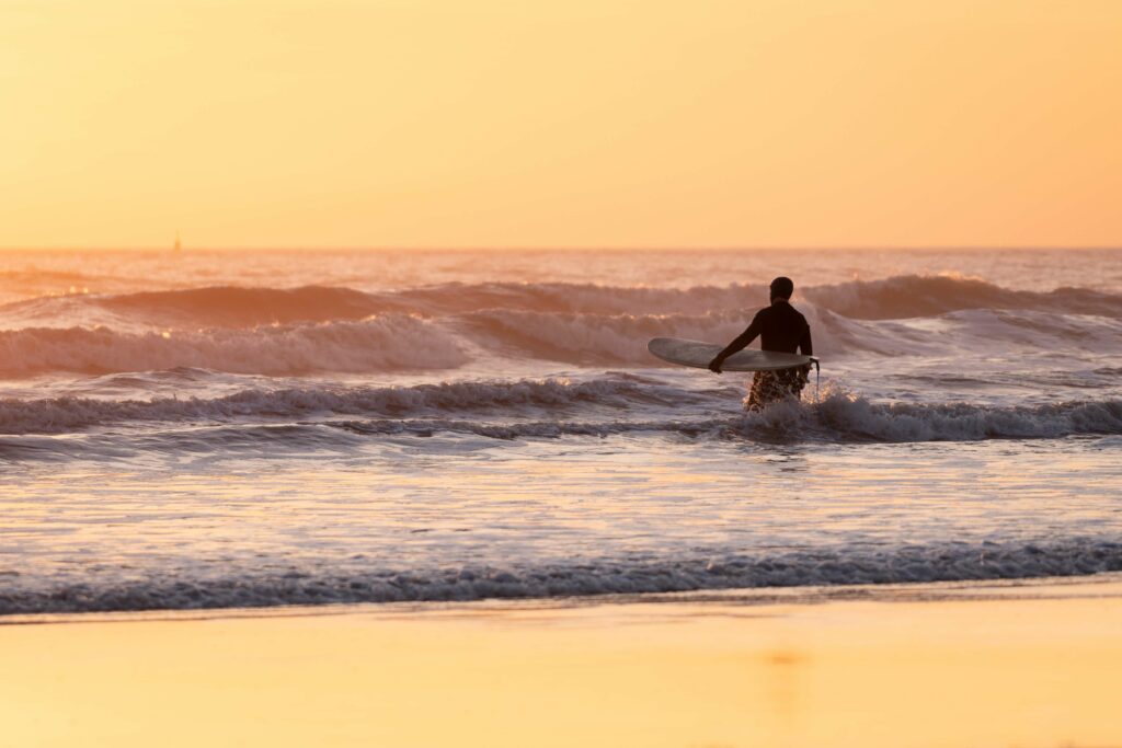 Porthcawl beach surfing at sunset - Top things to do in Bridgend 2023