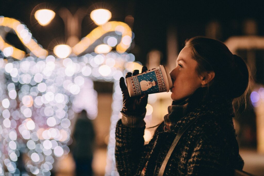 Cardiff Christmas Market 2023 - woman sipping on a hot drink from a cup